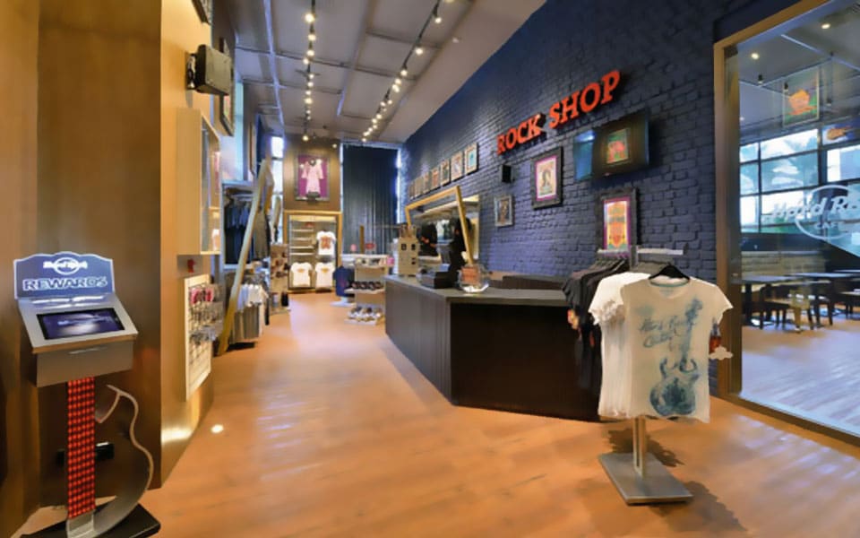 Rock Shop merchandise area with grey painted brick, timber display fixtures and a glazed cash counter